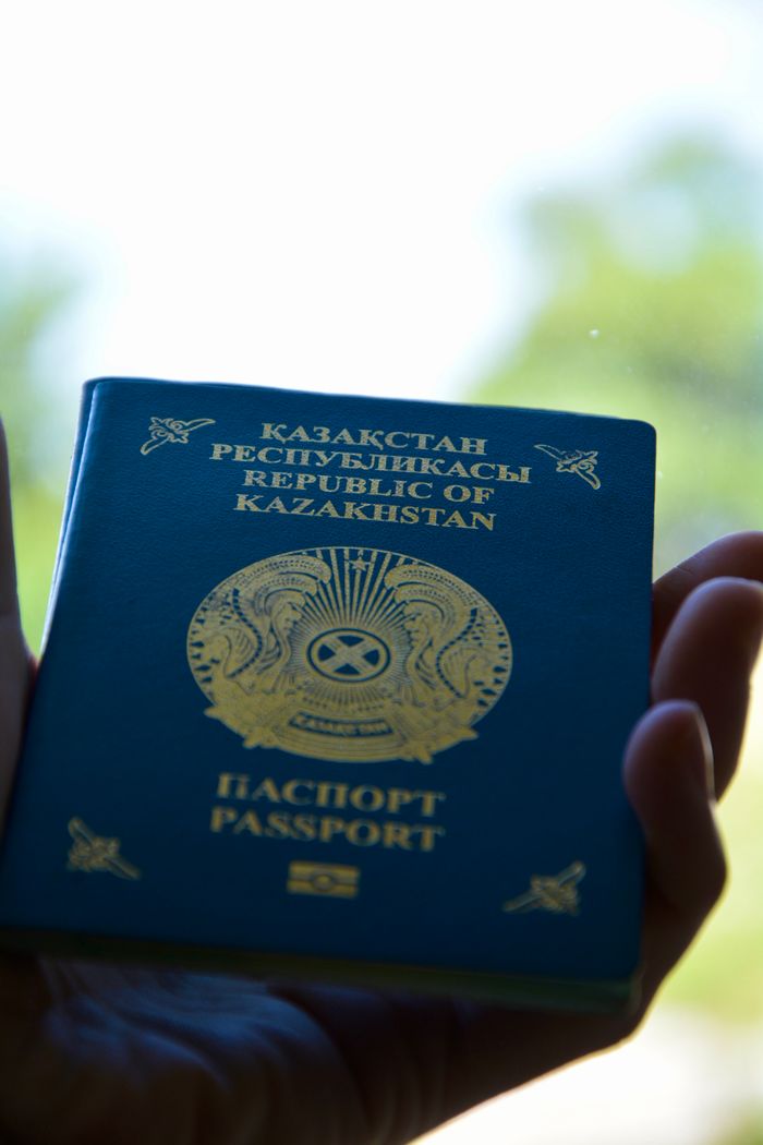 Mastering the First Impression: Your intriguing post title goes here Close-up of a Kazakhstan passport held in hand with a blurred background.